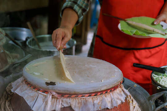 Woman cooking a Thai traditional dish Mee Phan