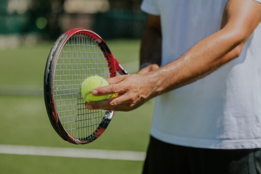 Tennis Player Prepares Serve on Sunny Court