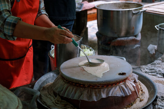 Woman cooking a Thai traditional dish Mee Phan