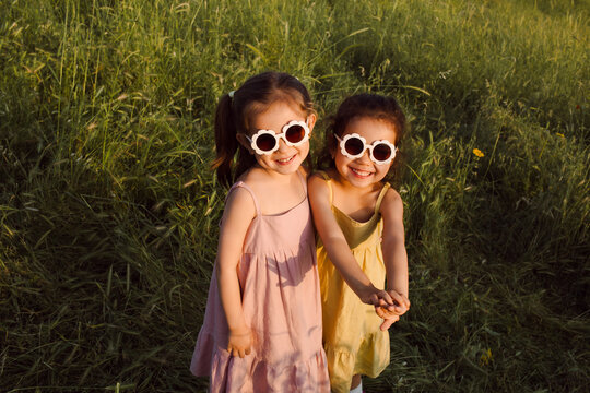 The sisters are standing in a field