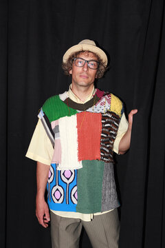 Man wearing a colorful patchwork sweater