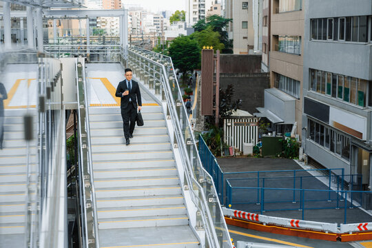 A businessman walks through the city
