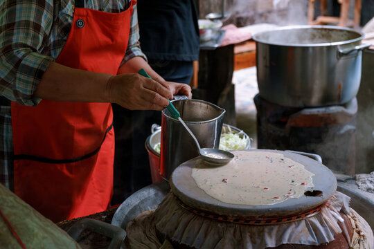 Woman cooking a Thai traditional dish Mee Phan