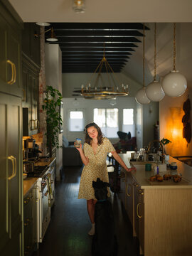 Woman on the kitchen with the dog 