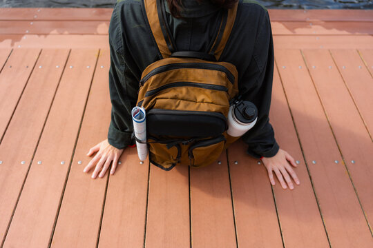 A tourist sits on the pier
