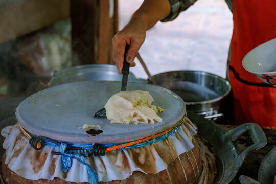Woman cooking a Thai Sukhothai-style Dry Noodles