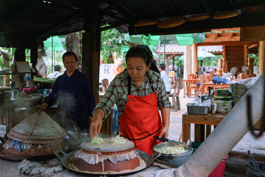 Woman cooking a Thai Sukhothai-style Dry Noodles