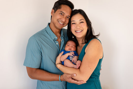 Happy parents hold baby