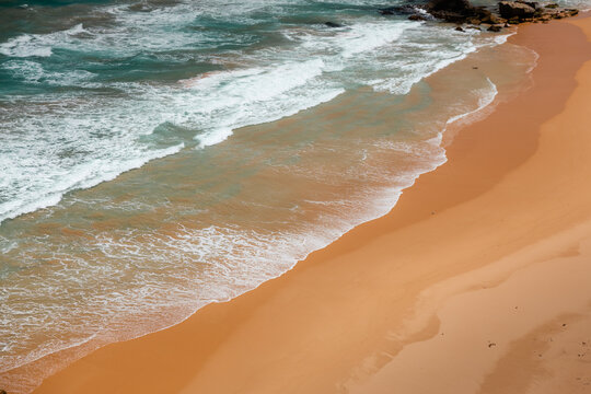 Golden sand beach with surf foam