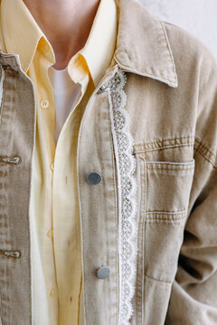 Person wearing a light brown jacket with lace detail