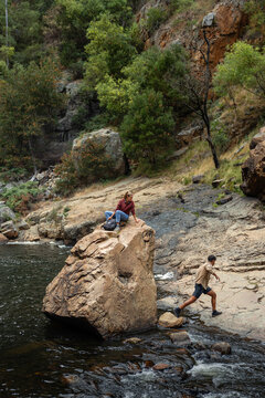 Friends enjoying a hike near a stream