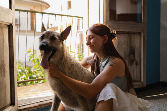 Happy Moments Shared Between a Woman and Her Dog Indoors