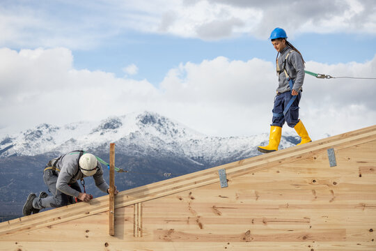 Two Workers on Wooden Roof