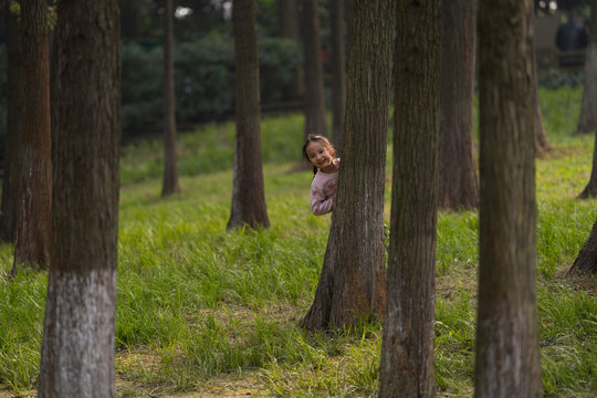 kid playing in the nature woods