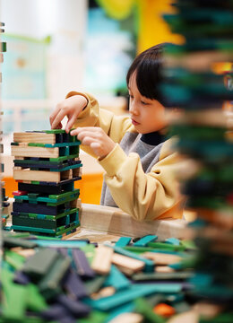 Chinese boy playing with building blocks