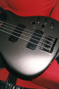 Close Up of Dark Electric Bass Guitar Under Direct Flash