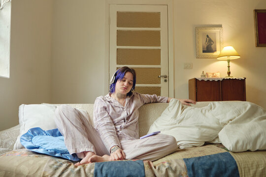 Non-binary person hearing and enjoying music in the morning