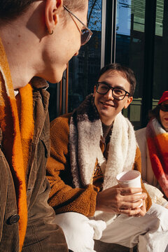 Friends share laughter and joy during a sunny winter day outdoors