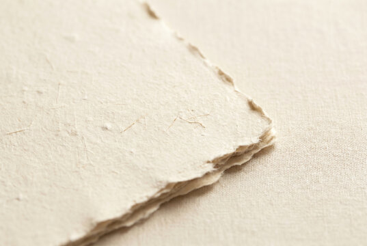 Handmade Recycled Paper Sheet with Deckled Edges on Linen Background