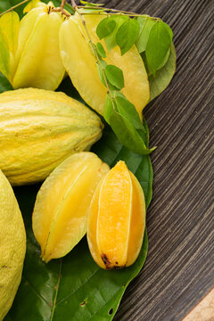 Tropical Fruit Variety on a Rustic Wooden Bowl