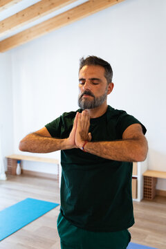 Man Practicing Yoga in a Studio During Daytime Hours