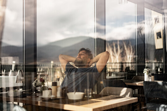 Man Relaxing in Restaurant