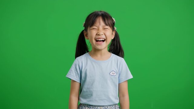 Cheerful Asian Little Girl Laughing Out Loud on Green Screen Key Background for Comedy Video, Children Education, Kids Advertising, Funny Reaction Footage, and Creative Presentation Content