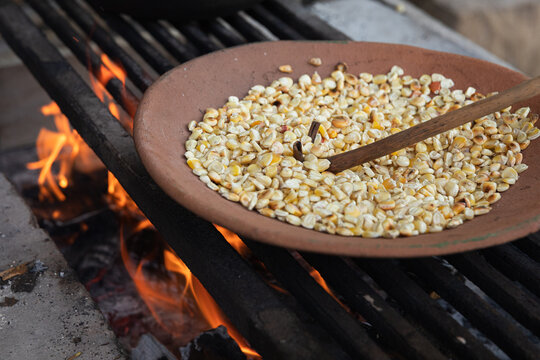 Roasting Corn Kernels on a Rustic Grill
