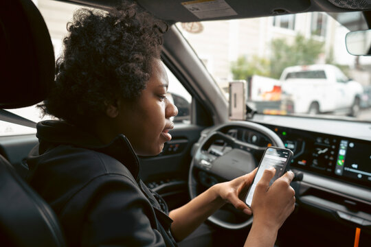 Woman using phone in car
