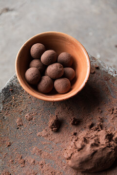 Handcrafted chocolate balls arranged in earthen bowl