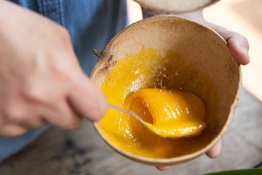 Egg yolk and sugar blend in a rustic bowl