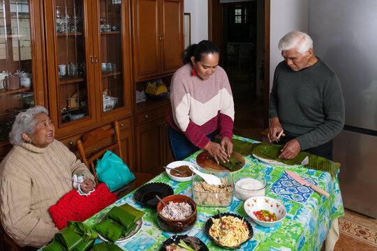 Intergenerational family moment cooking and crafting at home