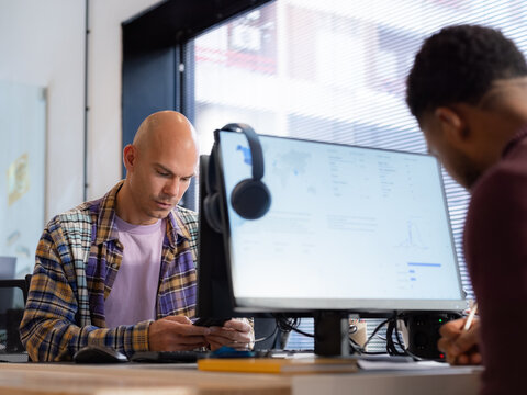 Two focused men working at office