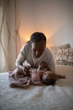 Mother monitoring newborn temperature at home 