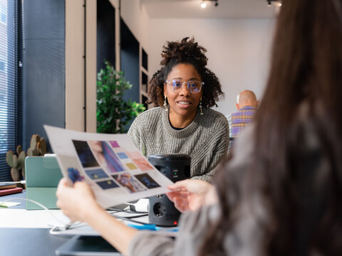 Women discussing design project at office 