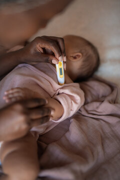 Checking Baby&rsquo;s Temperature During a Quiet Moment at Home