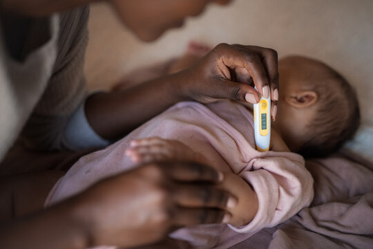 Mom checking baby temperature 