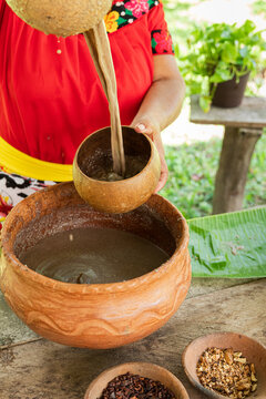 Serving pozol with a j&iacute;cara during traditional preparation