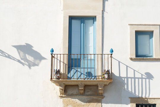 Balcony with Blue Shutters and Sunlight Shadow
