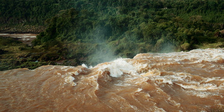 River Flows Over Rocks Near Green Forest During Daytime