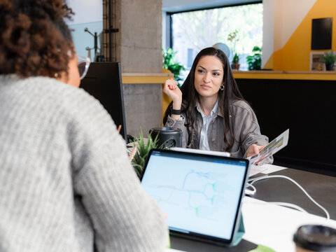 Office workers talking at work 