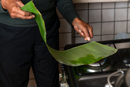 Preparing a Banana Leaf on a Stove for Cooking
