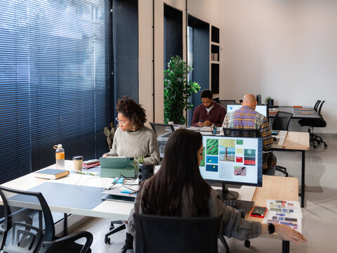 People Working in a Modern Office Space During Daytime Hours