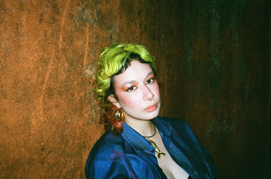 Colorful Hair girl Poses Against a Textured Wall