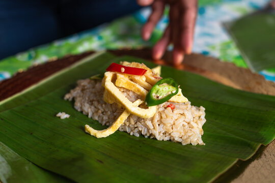Blending Flavors in Traditional Rice Dish Preparation in Home Kitchen
