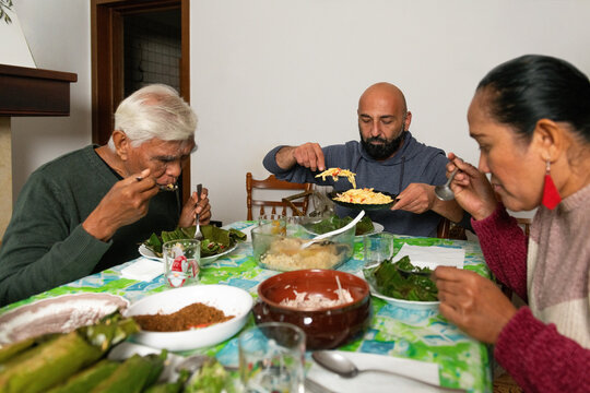 Family Enjoys Dinner Together in Home Setting With Simple Dishes