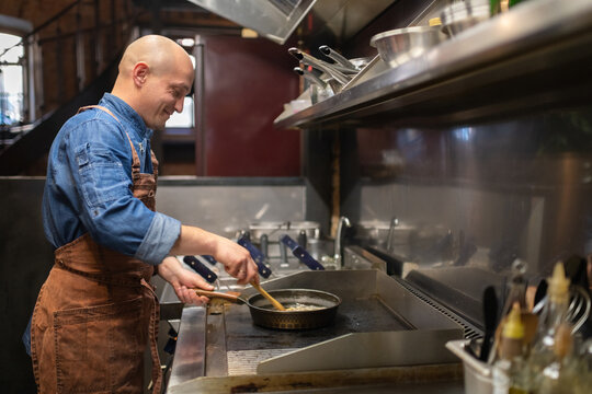 Positive cook frying food on stove