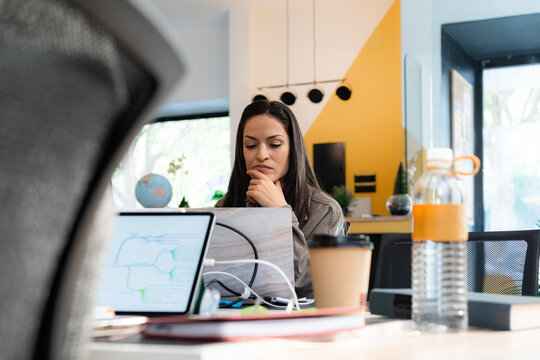 Woman thinking on business project in office