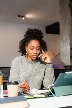 Busy woman making a phone call 