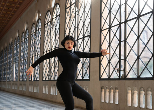 Graceful woman dancing in ballroom